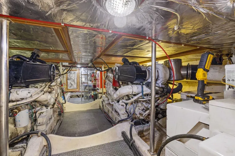 Slide: The Image of Engine room of 1991 Ocean Alexander 520 Pilothouse yacht, featuring dual engines and tools. - 51