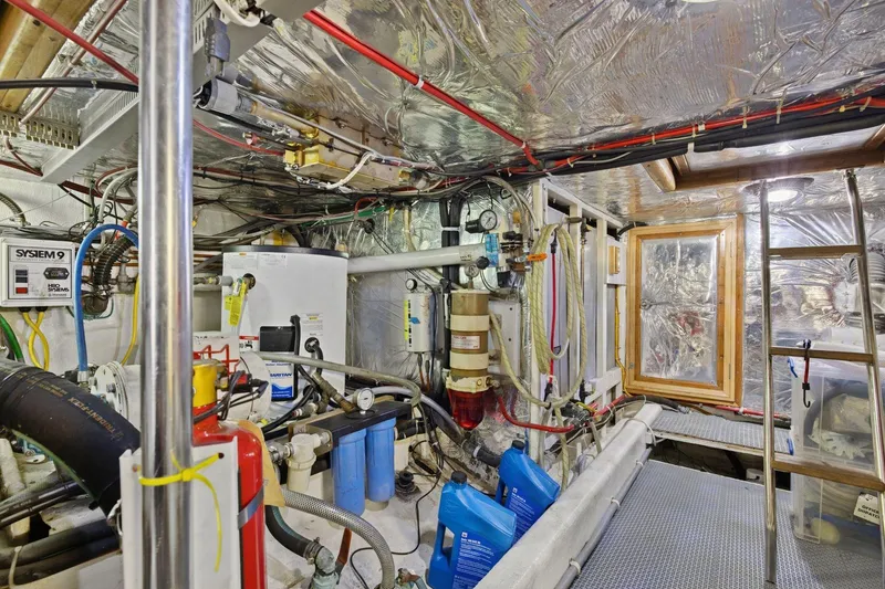 Slide: The Image of Engine room of 1991 Ocean Alexander 520 Pilothouse yacht, featuring equipment and storage. - 54