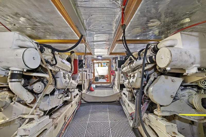 Slide: The Image of Engine room of 1991 Ocean Alexander 520 Pilothouse yacht, showcasing dual engines. - 55