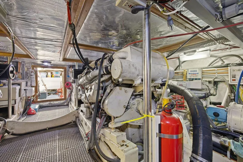 Slide: The Image of Engine room of 1991 Ocean Alexander 520 Pilothouse yacht, featuring machinery and equipment. - 57