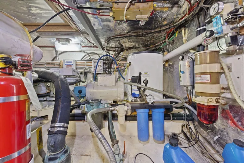 Slide: The Image of Engine room of 1991 Ocean Alexander 520 Pilothouse with equipment and piping. - 58