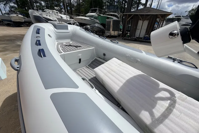 Slide: The Image of 2023 Highfield Classic 380 FCT inflatable boat interior with seating and steering wheel. - 19