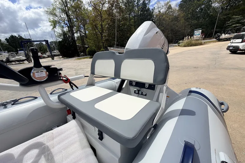 Slide: The Image of 2023 Highfield Classic 380 FCT boat with dual seats and outboard motor in a marina setting. - 21