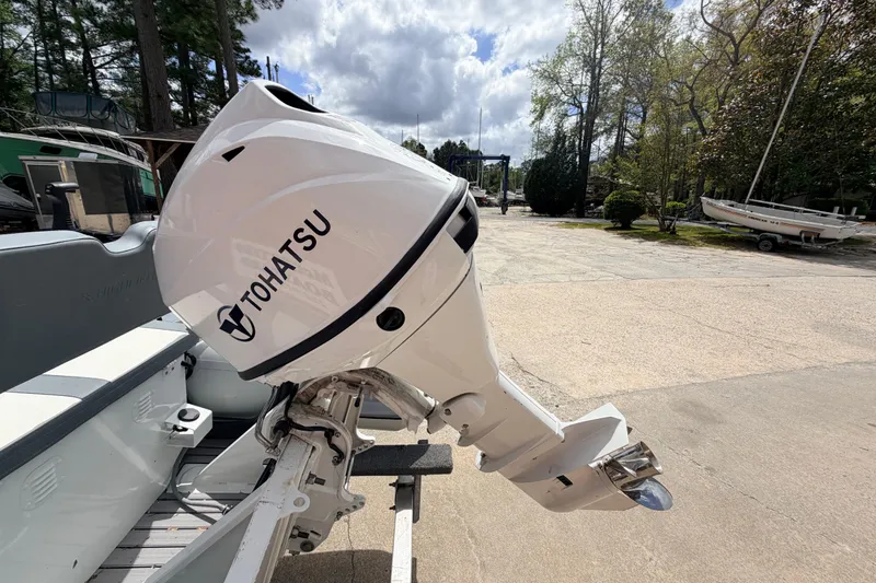 Slide: The Image of 2023 Highfield Classic 380 FCT with Tohatsu outboard motor in a marina setting. - 22