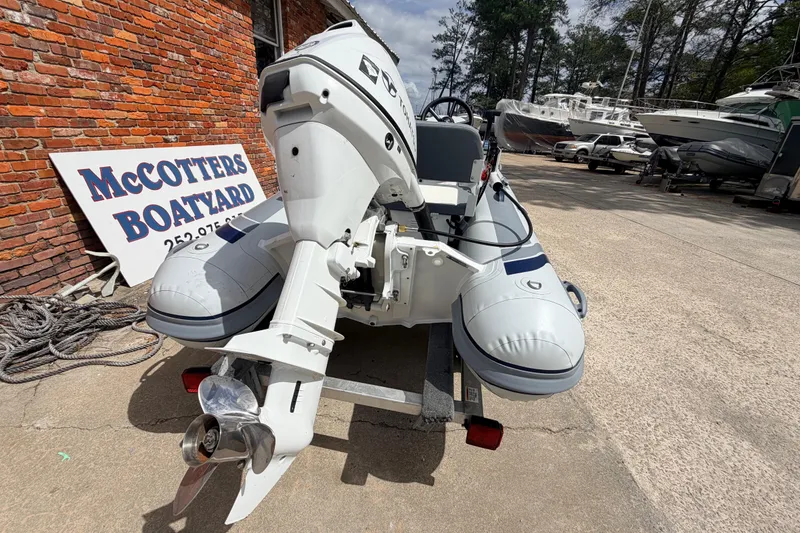 Slide: The Image of 2023 Highfield Classic 380 FCT boat at McCotters Boatyard, featuring an outboard motor. - 5