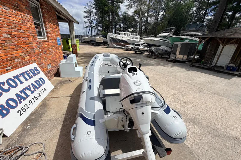 Slide: The Image of 2023 Highfield Classic 380 FCT boat at a boatyard with other vessels. - 6