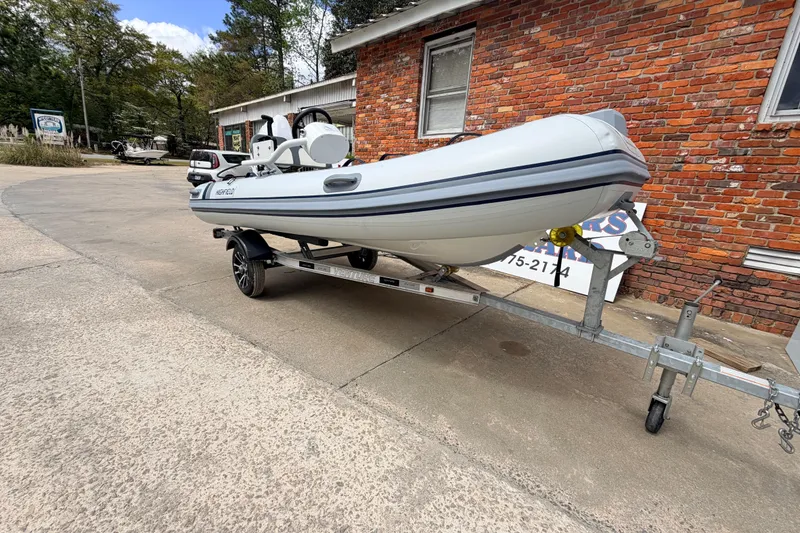 Slide: The Image of 2023 Highfield Classic 380 FCT boat on trailer, parked near brick building. - 8
