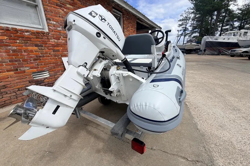 Slide: The Image of 2023 Highfield Classic 380 FCT boat with Tohatsu engine on a trailer. - 9