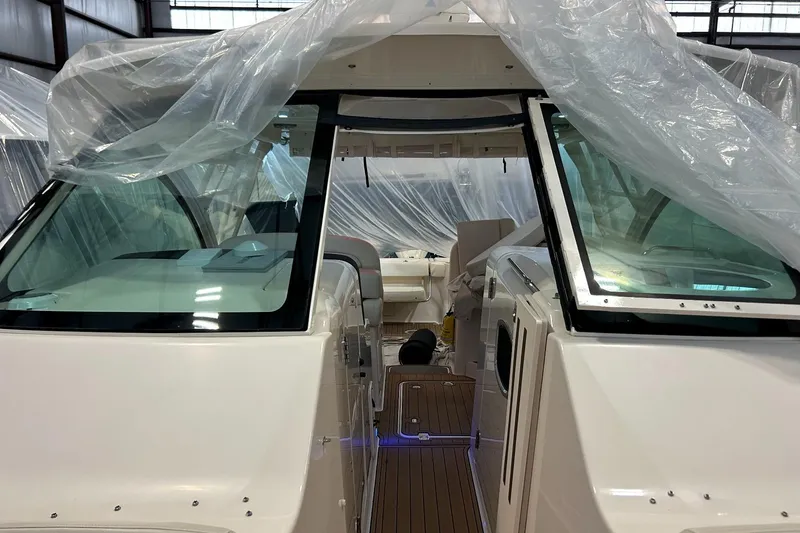 Slide: The Image of 2020 Grady-White Freedom 375 boat interior under protective plastic covering in a warehouse. - 12