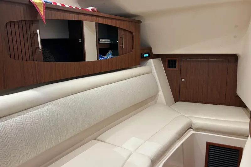 Slide: The Image of Interior of 2020 Grady-White Freedom 375 boat with cushioned seating and wooden cabinetry. - 17