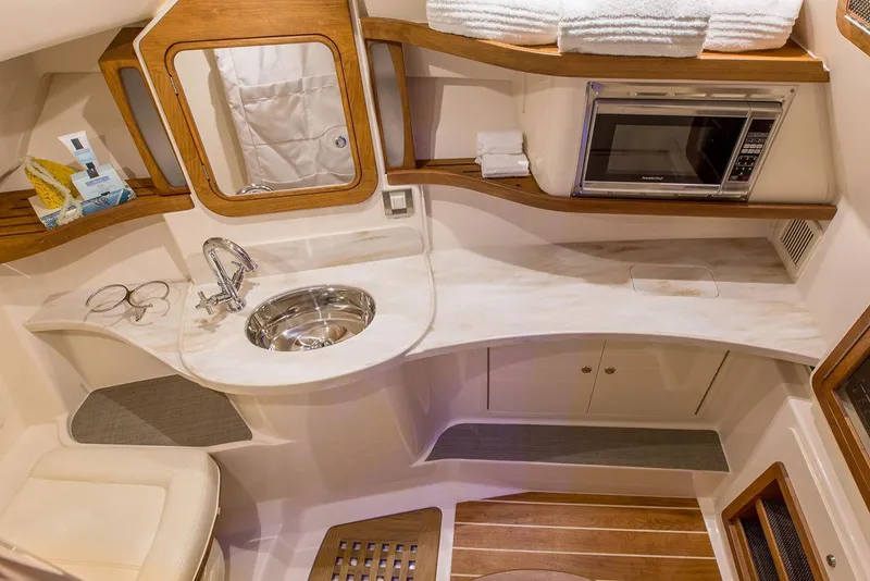 Slide: The Image of Manufacturer Provided Image: 2020 Grady-White Freedom 375 boat interior with kitchenette, sink, and microwave. - 19