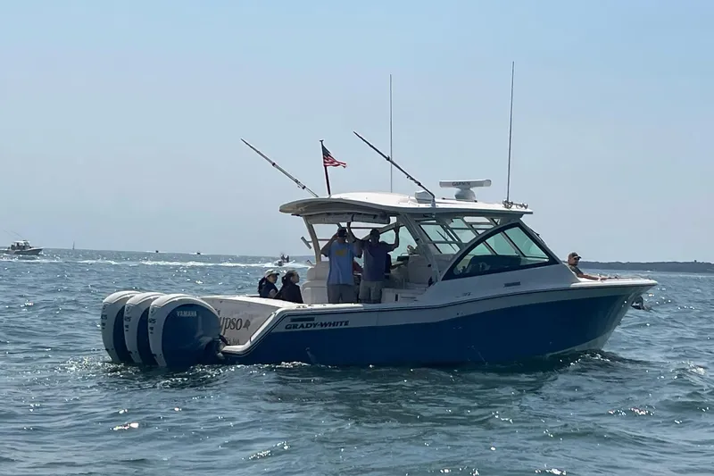 Slide: The Image of 2020 Grady-White Freedom 375 boat on water with passengers and fishing rods. - 2