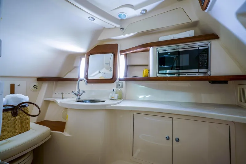 Slide: The Image of Manufacturer Provided Image: 2020 Grady-White Freedom 375 boat interior kitchen with sink, microwave, and storage. - 22