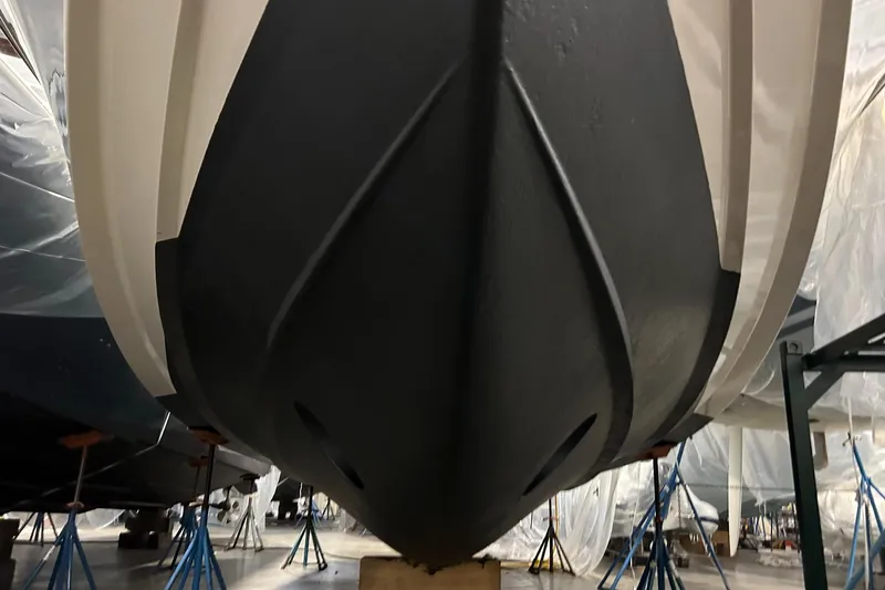 Slide: The Image of 2020 Grady-White Freedom 375 boat hull in storage, supported by stands. - 23