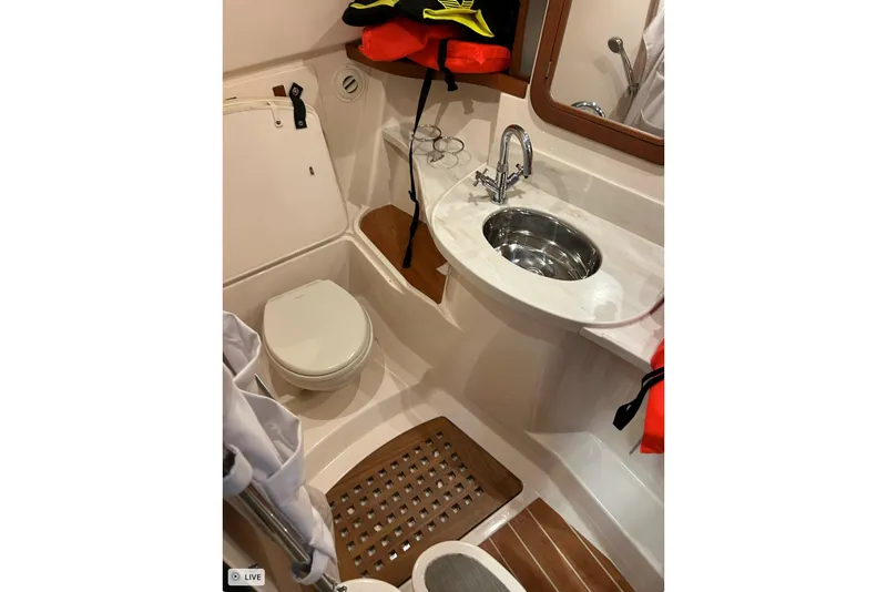 Slide: The Image of 2020 Grady-White Freedom 375 boat bathroom with sink, toilet, and life jackets. - 24