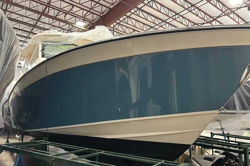 Slide: The Image of 2020 Grady-White Freedom 375 boat in storage, showcasing sleek blue hull design. - 4