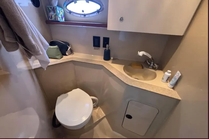Slide: The Image of 2005 Cruisers Yachts 280 CXi Express bathroom with sink, toilet, and storage. - 11