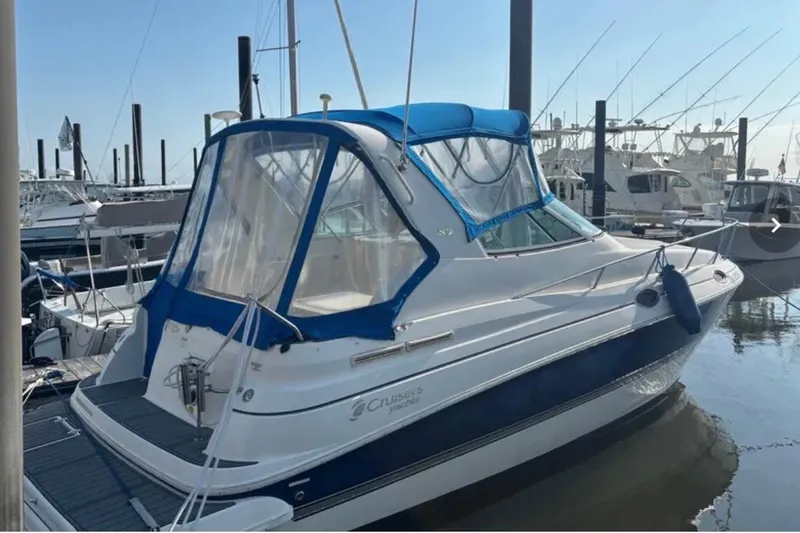 Slide: The Image of 2005 Cruisers Yachts 280 CXi Express docked at marina with blue canopy. - 3