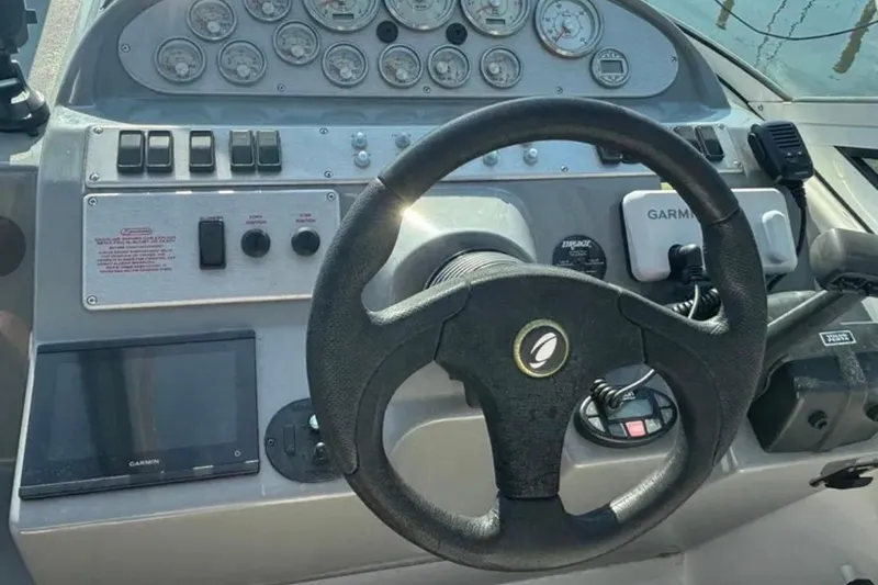 Slide: The Image of Steering console of 2005 Cruisers Yachts 280 CXi Express with gauges and Garmin device. - 7