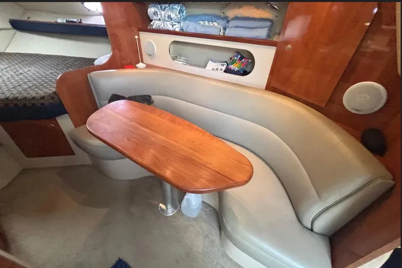 Slide: The Image of Interior of 2005 Cruisers Yachts 280 CXi Express with cozy seating and wooden table. - 8