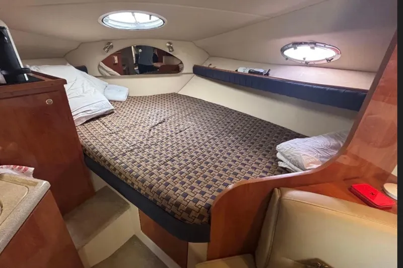 Slide: The Image of Interior cabin of 2005 Cruisers Yachts 280 CXi Express with bed and portholes. - 9
