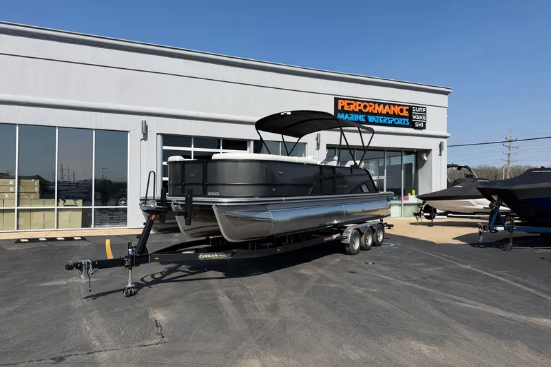 The Image of 2026 Crest Conquest 250 SLSC pontoon boat on trailer at marine dealership. - 1