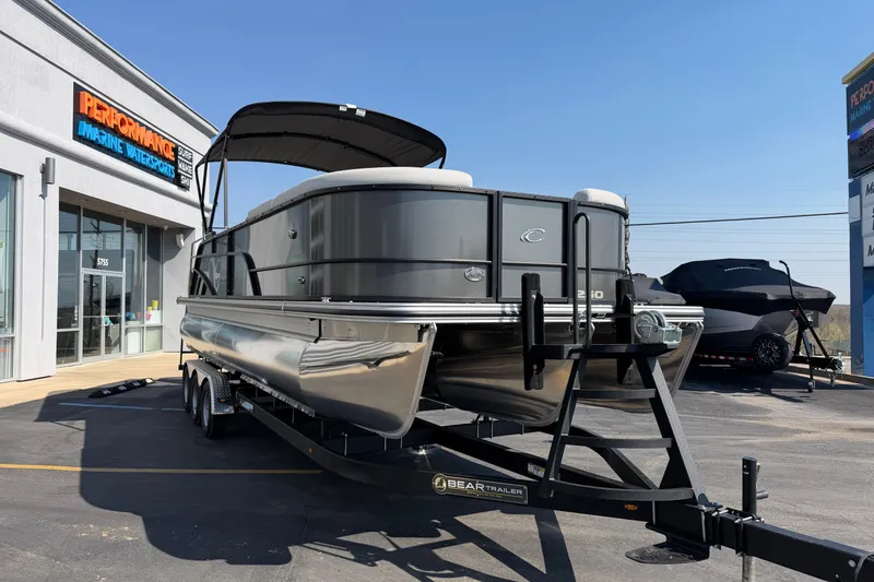 Slide: The Image of 2026 Crest Conquest 250 SLSC pontoon boat on trailer outside dealership. - 10