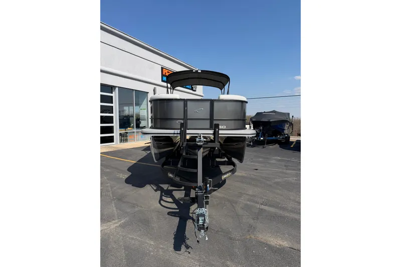 Slide: The Image of 2026 Crest Conquest 250 SLSC pontoon boat parked outside dealership on a sunny day. - 11