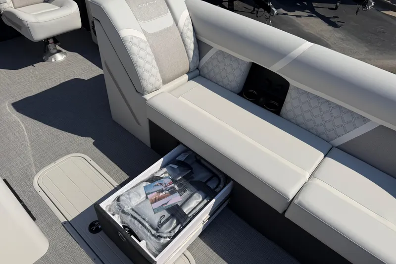 Slide: The Image of 2026 Crest Conquest 250 SLSC boat interior with storage compartment and seating. - 17