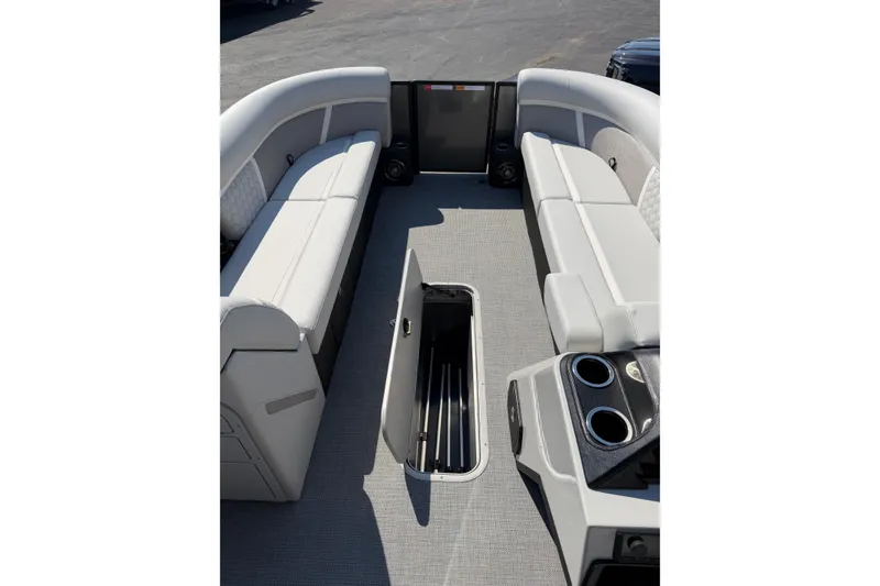 Slide: The Image of Interior view of 2026 Crest Conquest 250 SLSC boat with open storage compartment. - 18