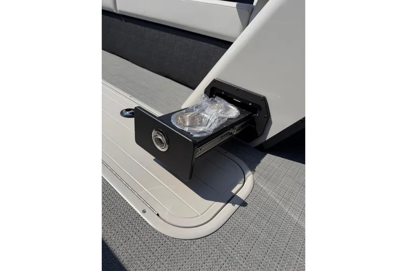 Slide: The Image of 2026 Crest Conquest 250 SLSC boat with a built-in storage compartment. - 19