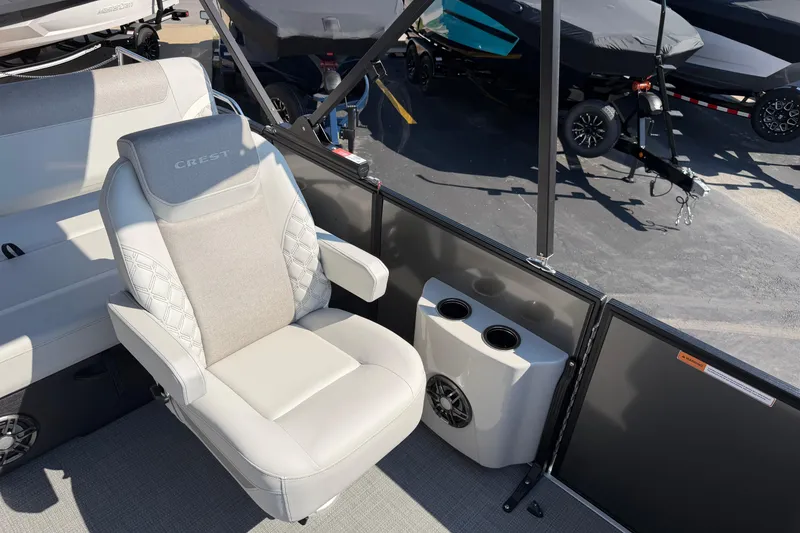 Slide: The Image of Luxurious seating on 2026 Crest Conquest 250 SLSC boat with cup holders and speaker. - 21