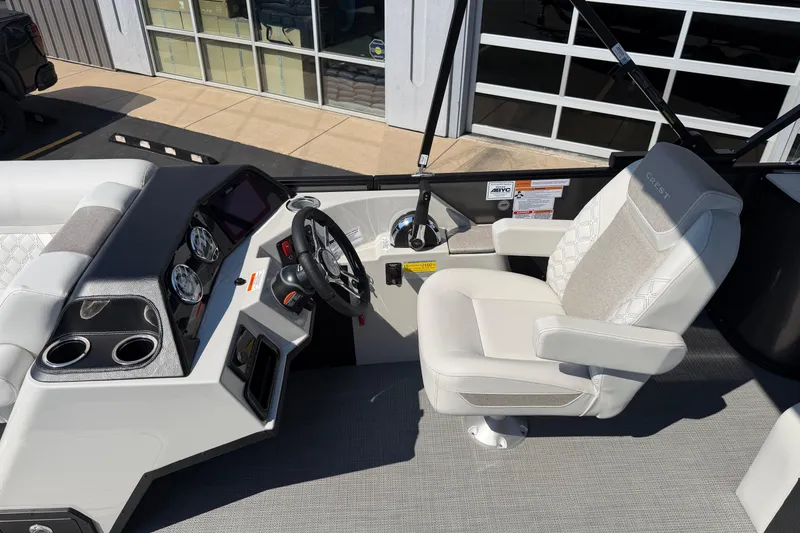 Slide: The Image of Helm of 2026 Crest Conquest 250 SLSC boat with modern controls and comfortable seating. - 22