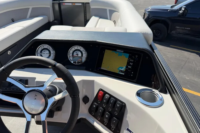 Slide: The Image of 2026 Crest Conquest 250 SLSC dashboard with steering wheel, gauges, and navigation display. - 23