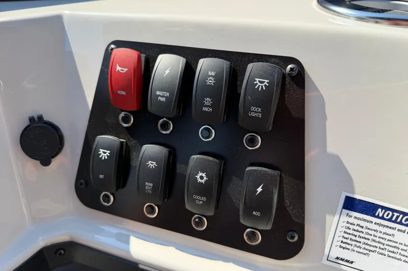 Slide: The Image of Control panel of 2026 Crest Conquest 250 SLSC boat with labeled switches. - 24