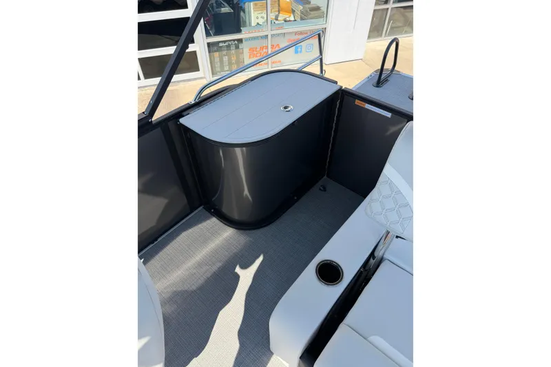 Slide: The Image of 2026 Crest Conquest 250 SLSC boat interior with seating and storage area. - 27