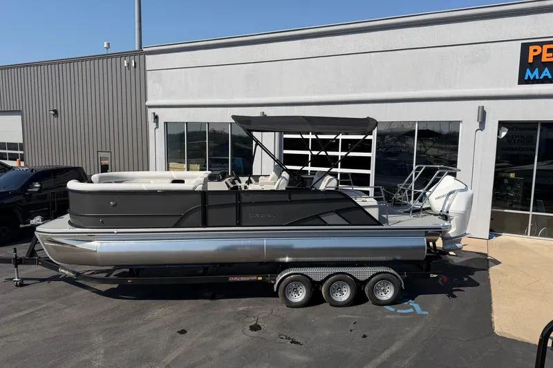Slide: The Image of 2026 Crest Conquest 250 SLSC pontoon boat on trailer outside dealership. - 4