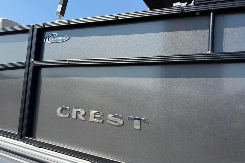 Slide: The Image of 2026 Crest Conquest 250 SLSC boat exterior with logo and sleek design. - 5