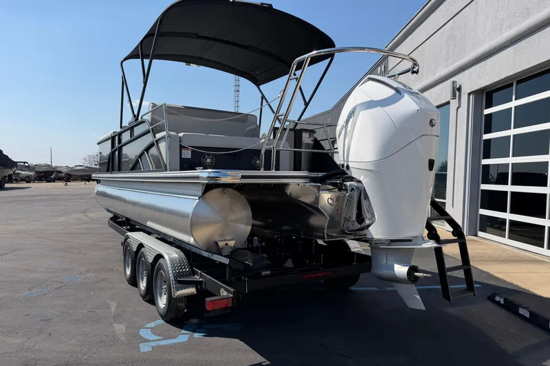 Slide: The Image of 2026 Crest Conquest 250 SLSC pontoon boat on trailer, parked outdoors. - 6