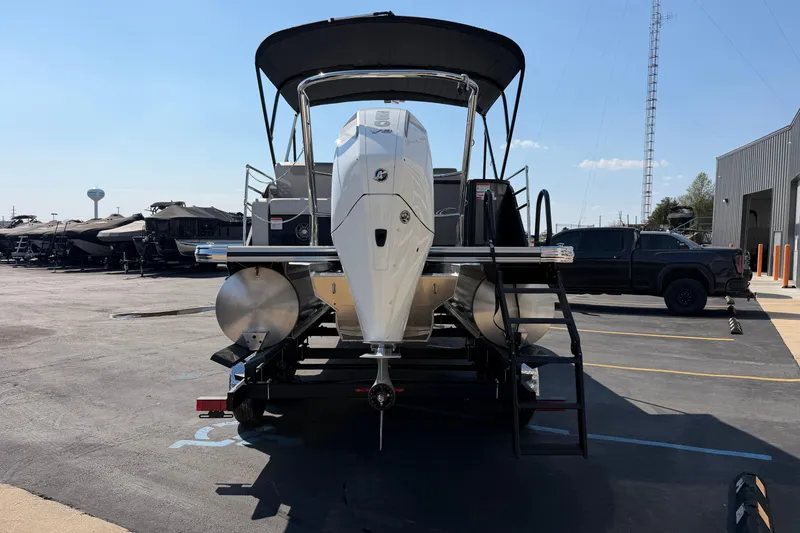 Slide: The Image of 2026 Crest Conquest 250 SLSC pontoon boat on trailer, rear view in a parking lot. - 7
