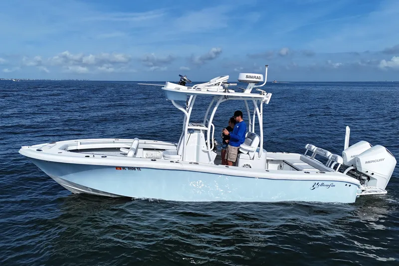 The Image of 2023 Yellowfin 26 Hybrid boat on open water with two people onboard. - 0