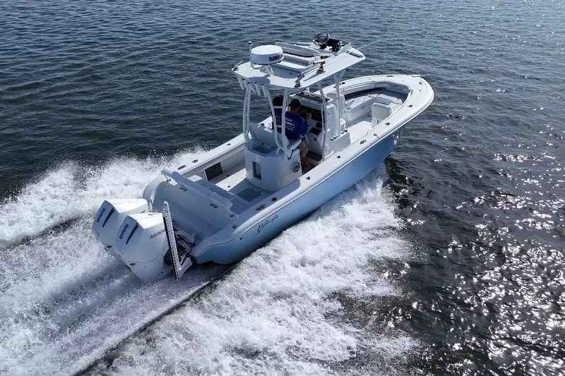 Slide: The Image of 2023 Yellowfin 26 Hybrid boat cruising on open water, showcasing powerful twin engines. - 10