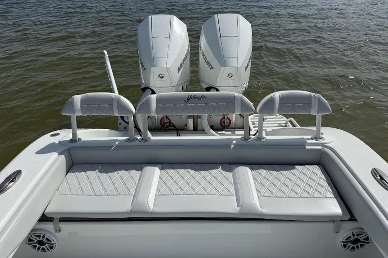 Slide: The Image of 2023 Yellowfin 26 Hybrid boat with dual Mercury engines on calm water. - 14