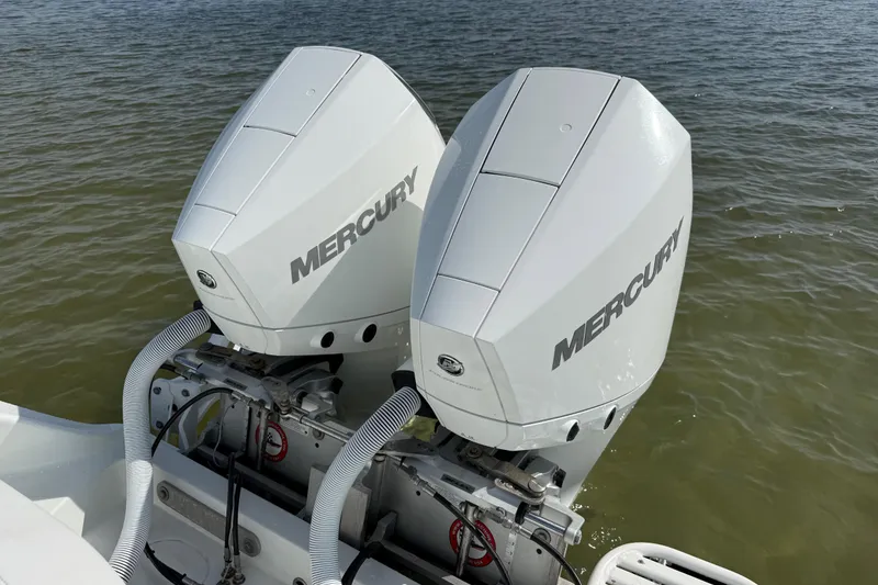 Slide: The Image of Twin Mercury outboard engines on a 2023 Yellowfin 26 Hybrid boat in water. - 16