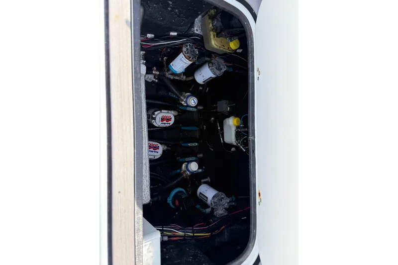 Slide: The Image of 2023 Yellowfin 26 Hybrid boat compartment with pumps and wiring. - 18