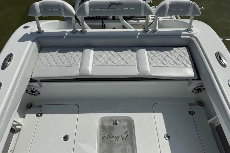 Slide: The Image of 2023 Yellowfin 26 Hybrid boat interior with cushioned seating and storage compartments. - 22