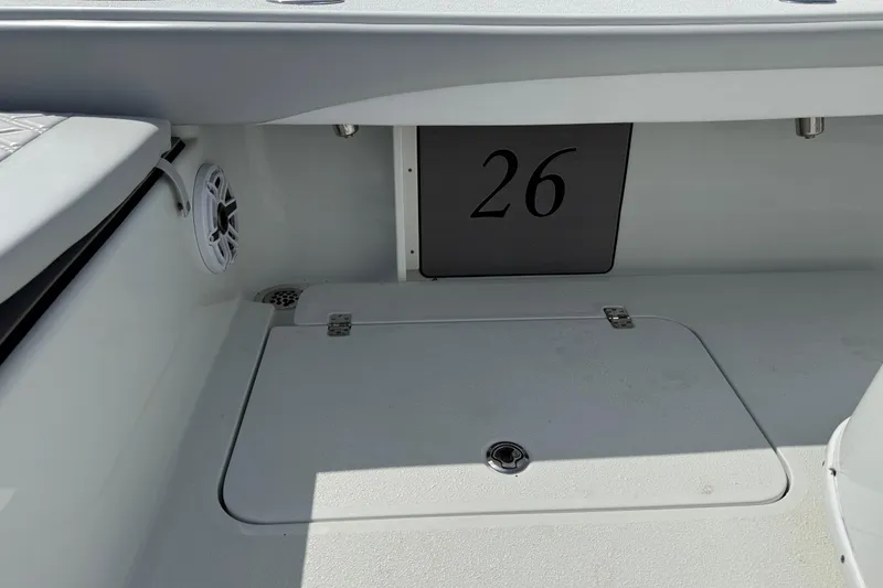 Slide: The Image of 2023 Yellowfin 26 Hybrid boat interior with speaker and storage compartment. - 23