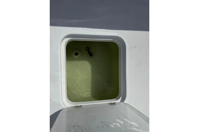Slide: The Image of Open hatch on 2023 Yellowfin 26 Hybrid boat, showing interior compartment. - 25