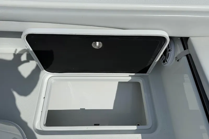 Slide: The Image of Open storage compartment on 2023 Yellowfin 26 Hybrid boat, showcasing interior space. - 26
