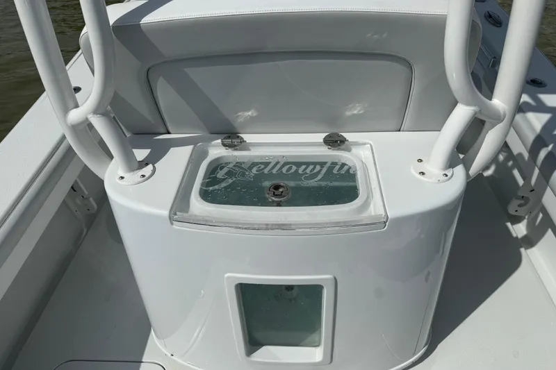 Slide: The Image of 2023 Yellowfin 26 Hybrid boat's livewell with clear lid and seating area. - 27
